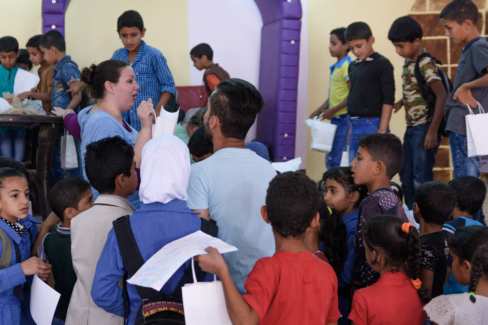 Chelsea and Mahmud distribute bags to eager children from Jerash refugee camp.
