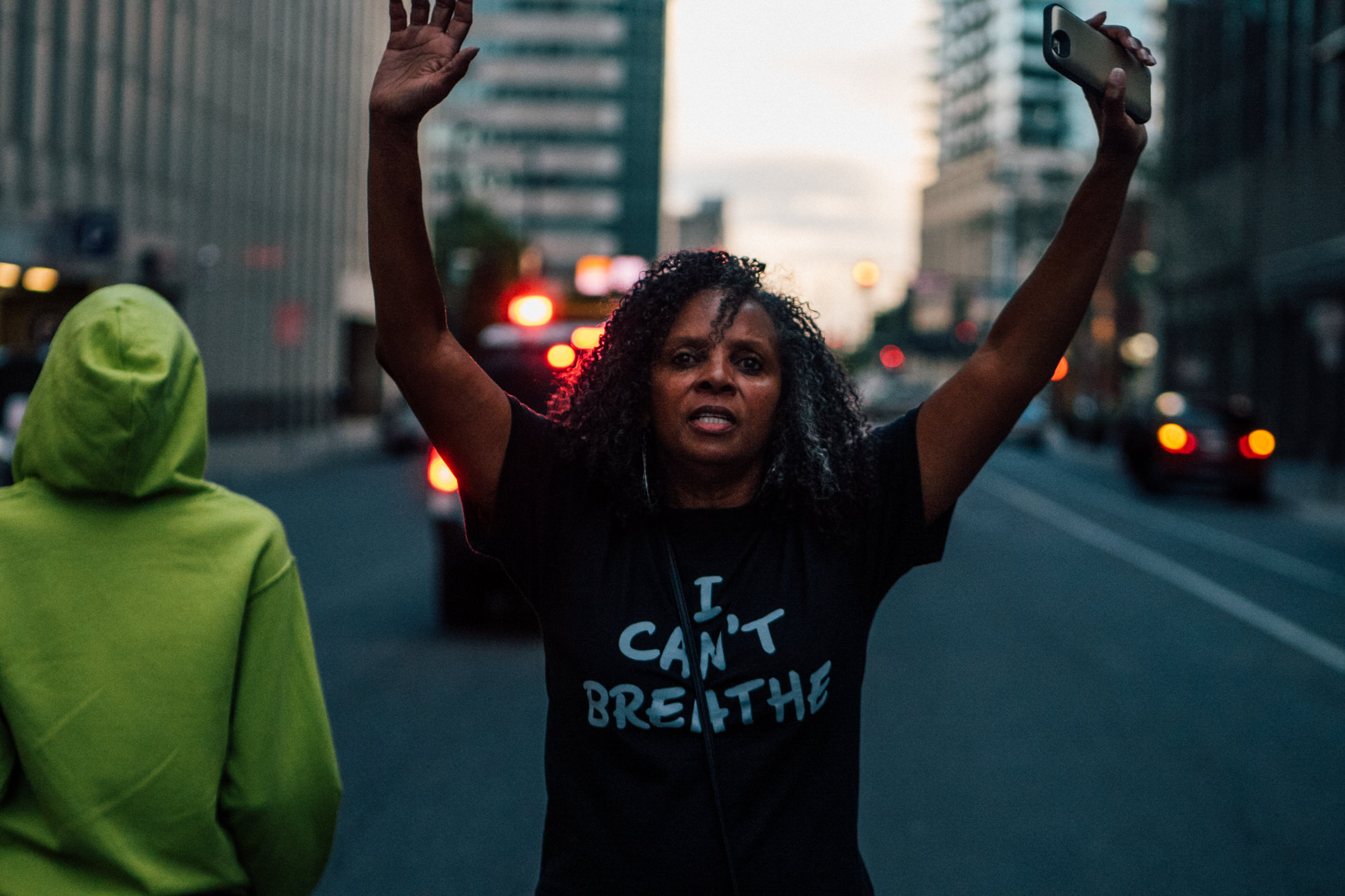A woman puts her hands up, a gesture that has become synonymous with the Black Lives Matter movement as participants of the BLM 5280 march chant "Hands up don’t shoot".